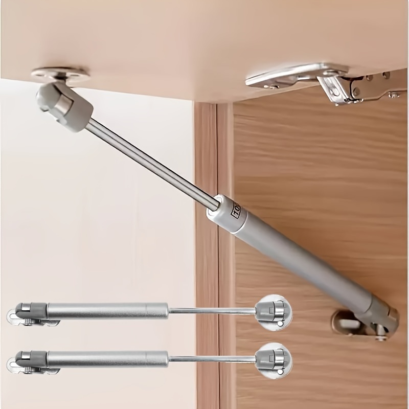 Dvojice hydraulických plynových pružin s jemným otevíráním pro dveře v klasickém stylu